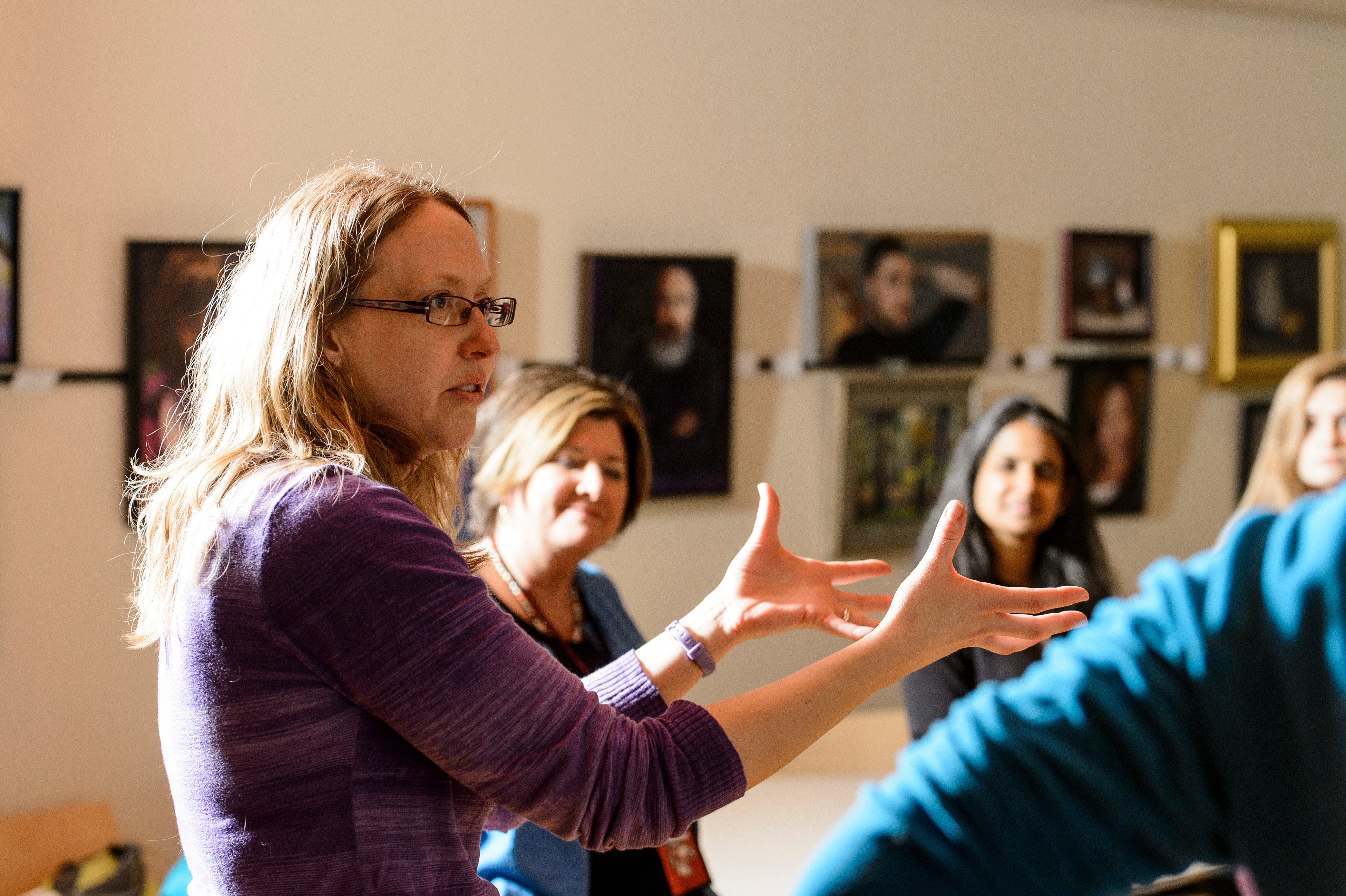a teacher expressively talking to a group of students