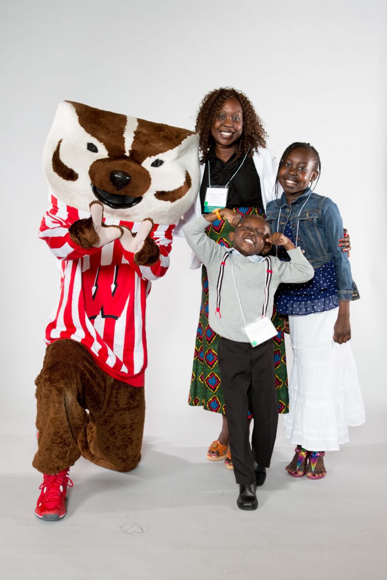 Scholarship recipient with her family and Bucky