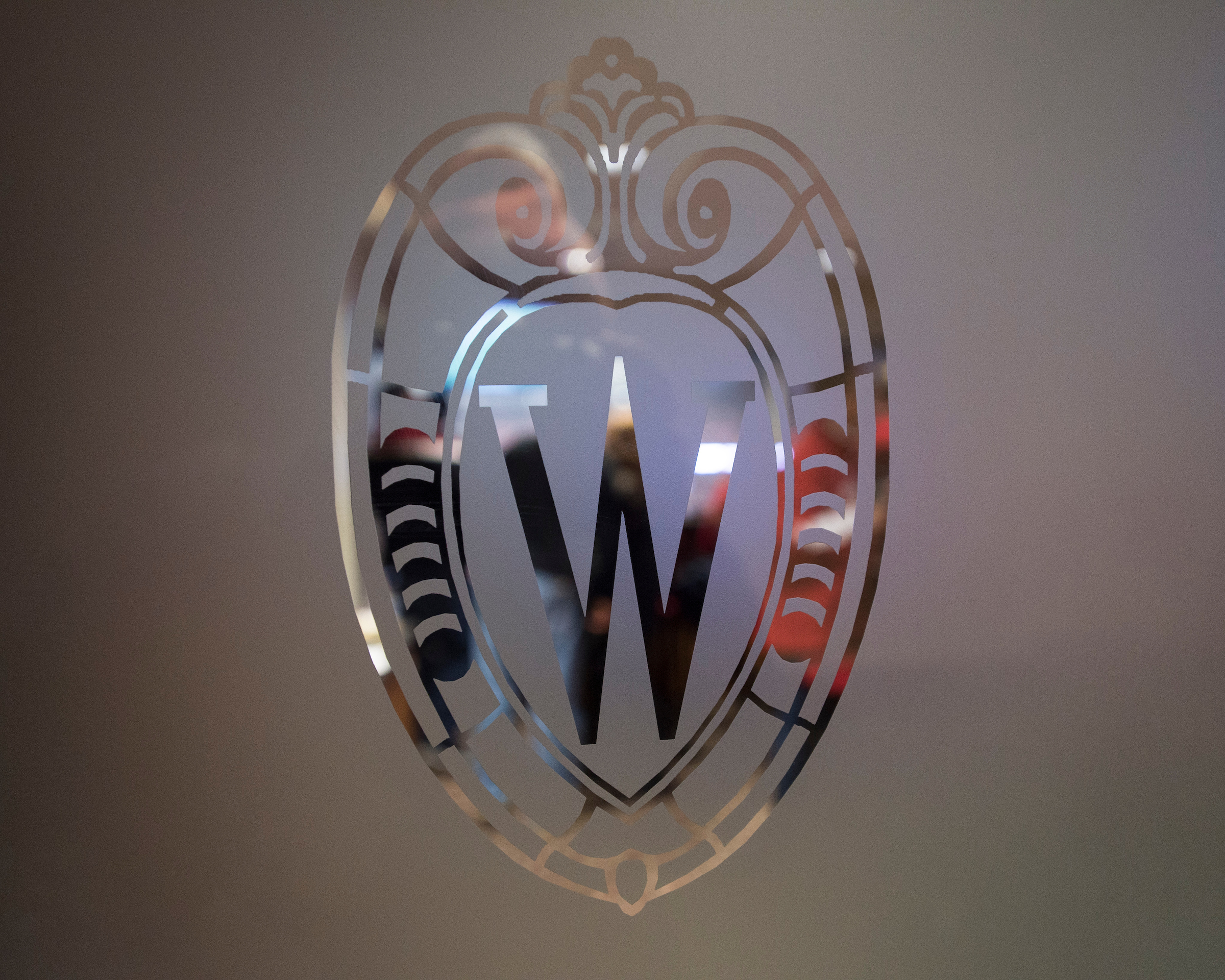 glass-etched Wisconsin crest