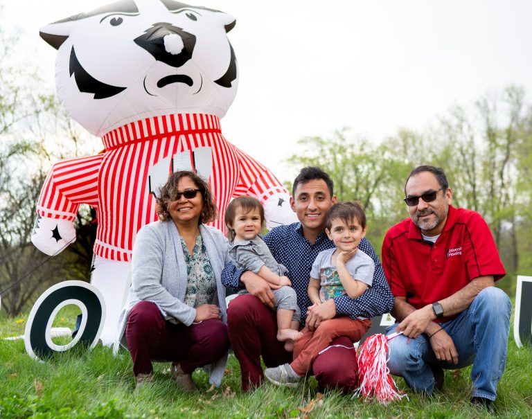 returning adult student and family with blow up Bucky