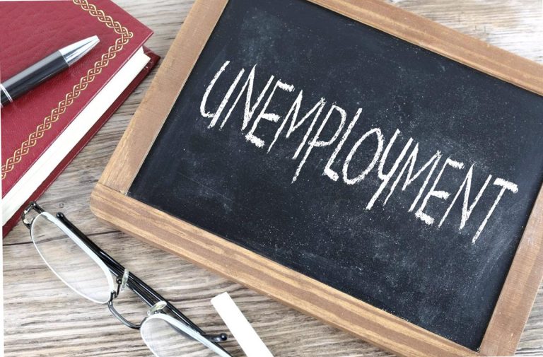 unemployment written on a blackboard