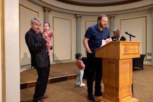 2023 Brendan Dowling with kids at podium; Martin Rouse holding baby